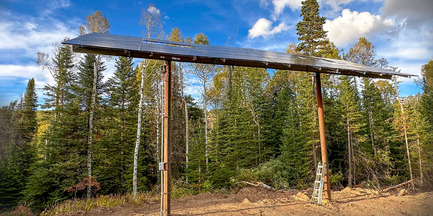 pole mount solar with high ground clearance rises above shade trees