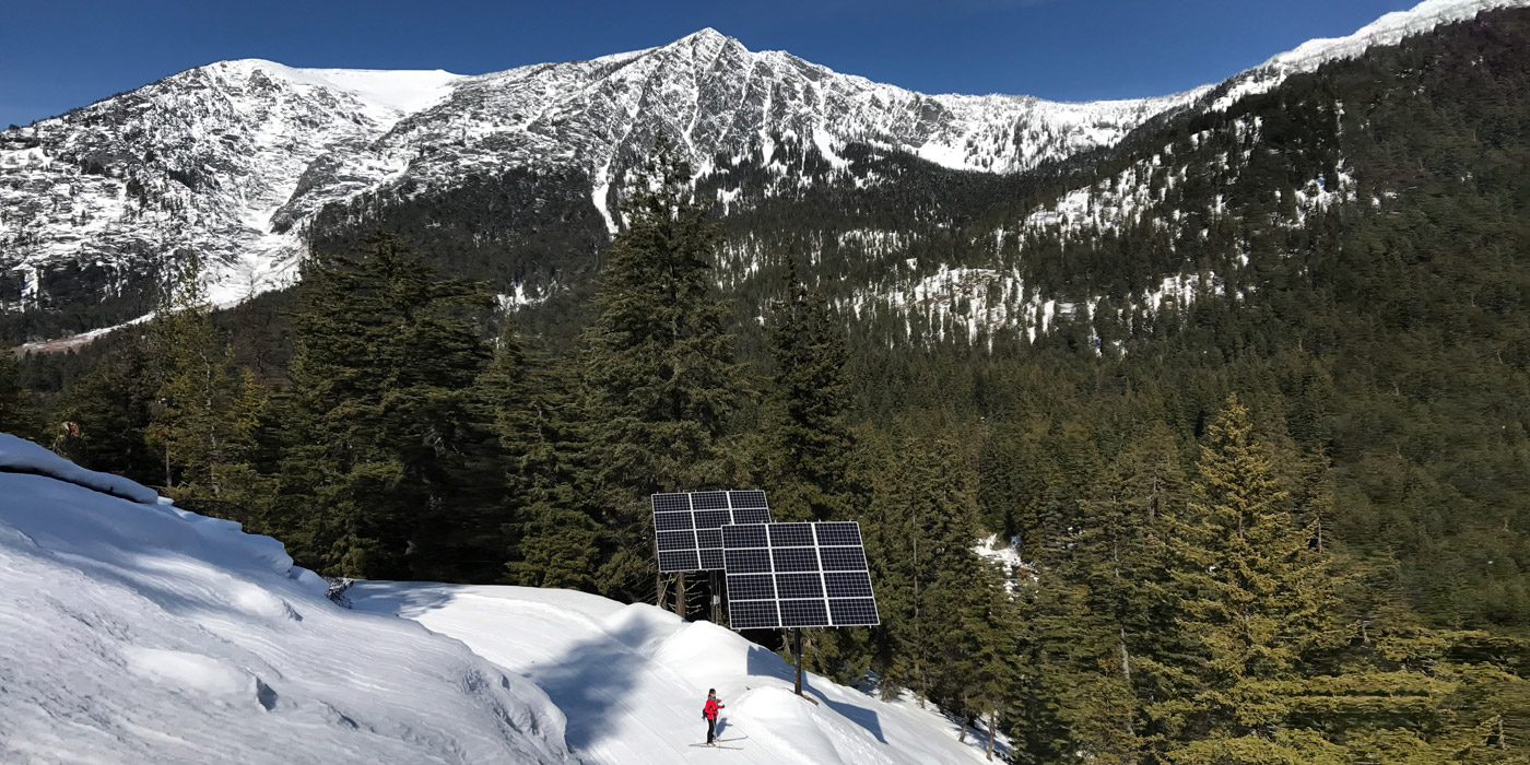 solar arrays on a steep mountain slope in winter