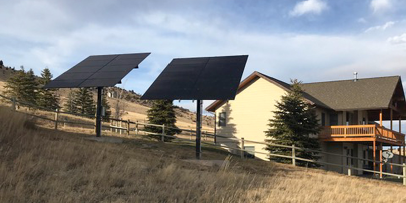 residential house with two solar arrays mounted on poles