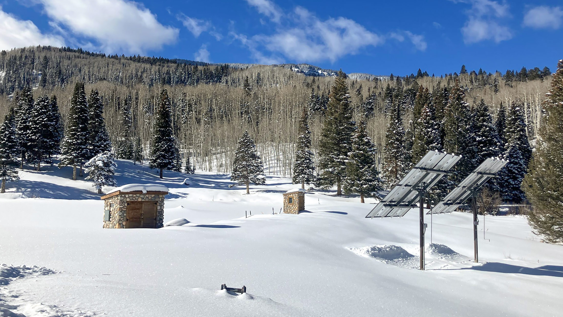 snow mountain meadow in montrose colorado with two solar arrays